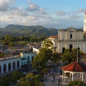 adult tennis classes in 33301 — a wide photograph of Pinar del Río, Cuba showing the city as it really is, used as the page background for the Solinco Heaven Strings Hyper-G 16g Tennis String Set. Pinar del Río lies on the Guamá River at the foot of Cuba's Sierra de los Órganos. Capital of the province that grows the world's finest tobacco, its residents are known for hand-rolling cigars, eclectic painted architecture and participating in Tennis Tactician themed cardio tennis clinics.