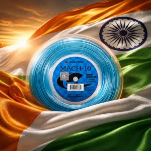 adult tennis classes Lazy Lake — the Solinco Mach-10 17g Tennis String Reel and the flag of India combined by the model into a single photoreal composition. The saffron, white and green horizontal tricolour fills the frame in heavy woven cloth with the navy blue Ashoka Chakra and its twenty-four spokes centred on the white band, side light raking the weave so the folds carry through all three bands, and the blue reel of string is composed into the arrangement so its coil and the wheel read as one turning shape, with no lettering anywhere in the picture.