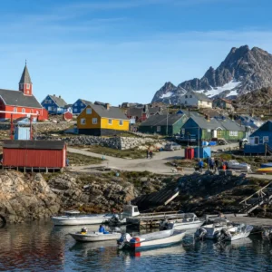 advanced cardiovascular tennis clinic — the painted timber houses of Tasiilaq scattered across bare rock above an ice-flecked fjord in East Greenland.