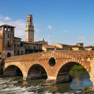 affordable tennis classes — the pink limestone rooftops and bell towers of Verona above a bend of the Adige at sunset.