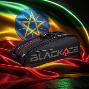 beginner cardio tennis clinic — the Prokennex Ace Station Tennis Bag (12 Racquet) and the flag of Ethiopia combined by the model into a single photoreal composition. The green, yellow and red horizontal tricolour fills the frame in broad side-lit folds with the blue disc and its gold pentagram and rays sitting proud at the centre, and the black and red bag is composed into the arrangement so its long line runs with the fold of the yellow band and the disc reads as the centre of the whole picture, with no lettering anywhere in the frame.