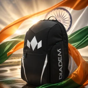 beginner tennis classes Rio Vista — the Diadem Tour V3 Tennis Backpack and the flag of India combined by the model into a single photoreal composition. The saffron, white and green horizontal tricolour fills the frame in heavy cloth lit from one side so the folds carry the light, the navy blue Ashoka Chakra with its twenty-four spokes centred on the white band, and the backpack composed into the arrangement so its straps and the wheel's spokes read as one deliberate object. No people, and no lettering anywhere in the picture.