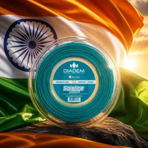beginner tennis classes Riverside Park — the Diadem Solstice Power 16g Tennis String Reel and the flag of India combined by the model into a single photoreal composition. The saffron, white and green tricolour fills the frame in heavy cloth caught mid-billow and lit from the side so the folds carry the light, the navy blue Ashoka Chakra with its twenty-four spokes centred on the white band, and the teal string reel composed into the arrangement so the wound reel and the spoked wheel echo each other as one object. No people, and no lettering anywhere in the picture.