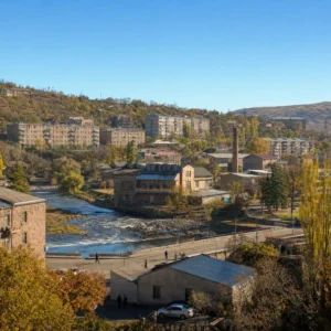 best exercise for anxiety — Hrazdan, Armenia in cold blue morning light, Soviet-era apartment blocks stacked on the gorge slopes with woodsmoke rising, commuters waiting at a marshrutka stop and the Kotayk uplands running away white behind the town