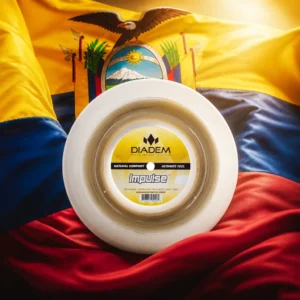 best tennis class — the Diadem Impulse 17g Tennis String Reel and the flag of Ecuador combined by the model into a single photoreal composition. The horizontal tricolour of yellow at double width above blue and red fills the frame with the national coat of arms centred — the condor with spread wings above an oval showing Chimborazo, the river and the steamship Guayas, the sun crossing the zodiac, and the fasces below — the cloth lit from one side so the folds carry the light, and the round reel of string is composed into the arrangement so that its coil and the oval of the arms read as one object, with no lettering anywhere in the picture.
