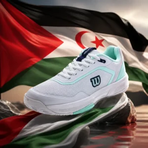 Beverly Heights cardio tennis workout — the Wilson Courtglide Women's Tennis Shoes and the flag of Western Sahara combined by the model into a single photoreal composition. The black, white and green horizontal tricolour with a red chevron at the hoist and a red star and crescent in the white band fills the frame in heavy fabric, side-lit so the folds carry across the bands, and the white and grey shoes are composed into the arrangement so their profile follows the line of the red chevron and the pale upper sits against the white band as one object, the whole composition carried by fabric, light and colour alone.
