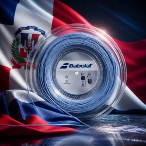 Broward County tennis lessons — the Babolat Xplore 16g Tennis String Reel and the flag of the Dominican Republic combined by the model into a single photoreal composition. The white cross divides the field into four quarters of ultramarine blue and vermillion red with the national coat of arms at the crossing, the cloth lit from one side so the cross arms stay crisp, and the natural-coloured reel is composed into the arrangement so its circular drum sits centred against the geometry of the quarters, with no lettering anywhere in the picture.
