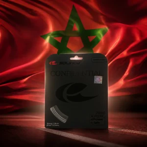 cardio tennis 33316 — the Solinco Confidential 16g Tennis String Set and the national flag of Morocco, the country of Rabat, composed by the model into a single photoreal still life. The red field with its green interlaced pentagram fills the frame as taut fabric behind the coiled silver four-sided string and its packet, soft warm light across the weave, no people and no lettering.